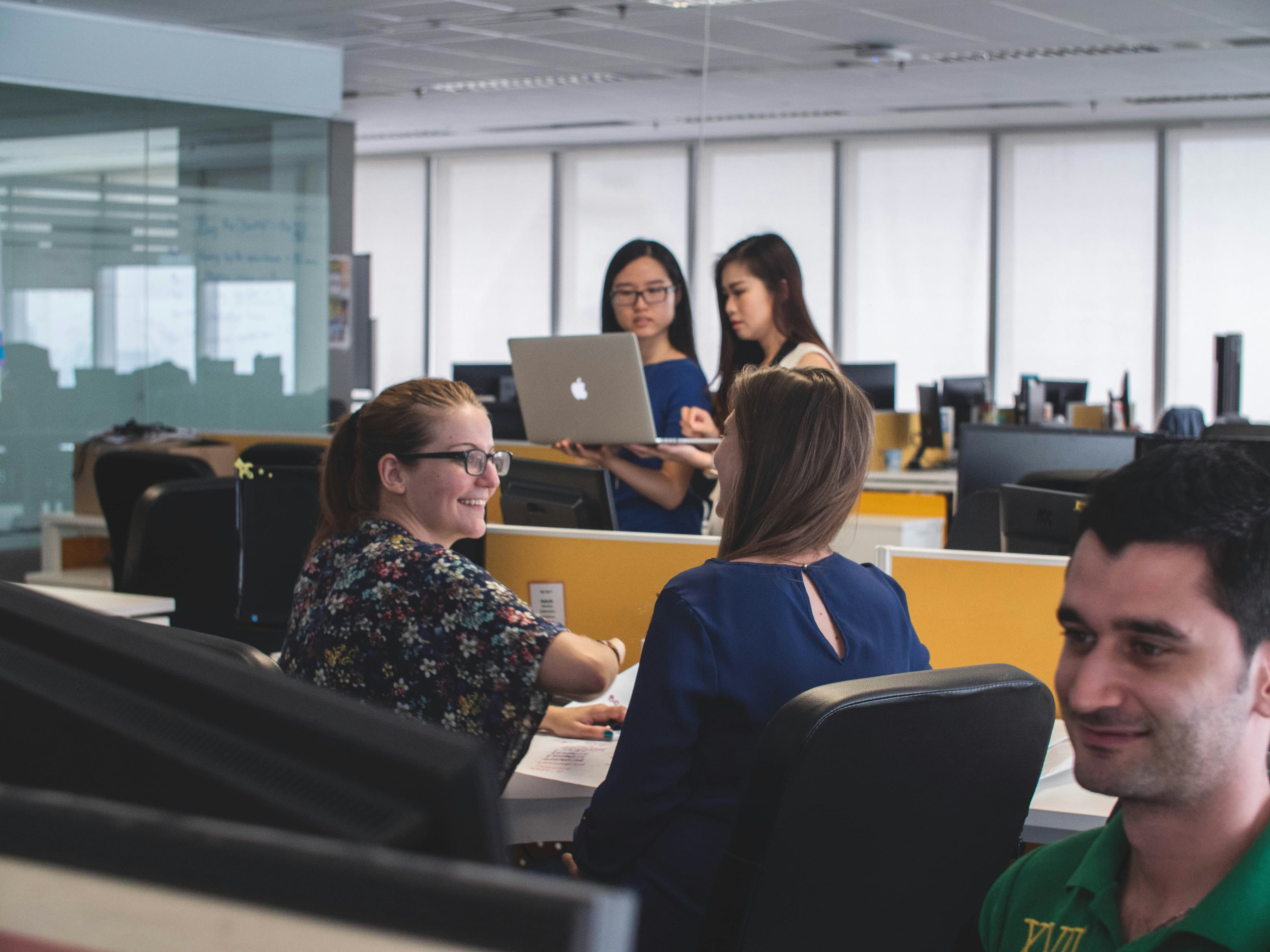 A group of colleagues working and collaborating in an office