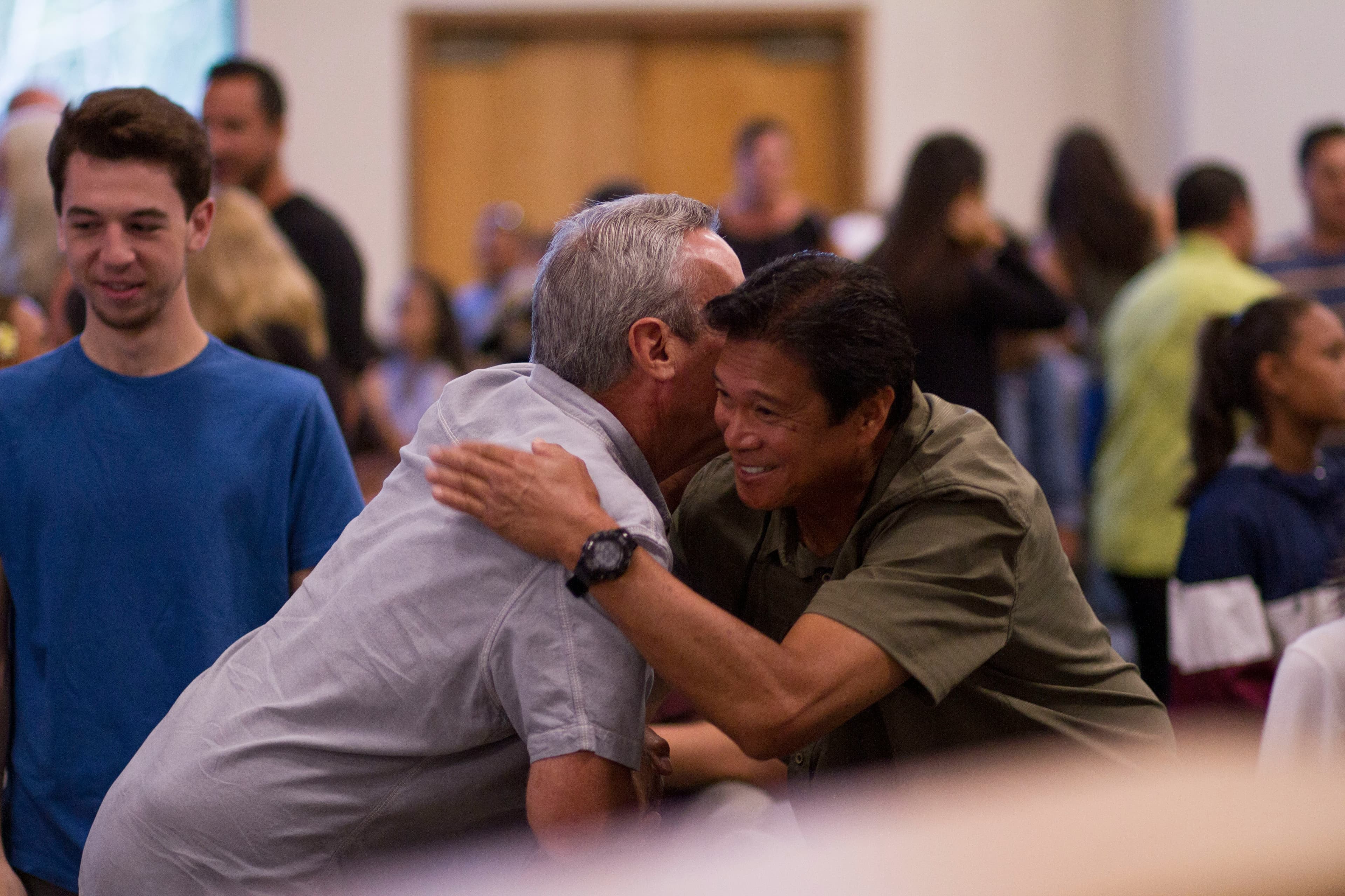 Two men greeting each-other at a community event